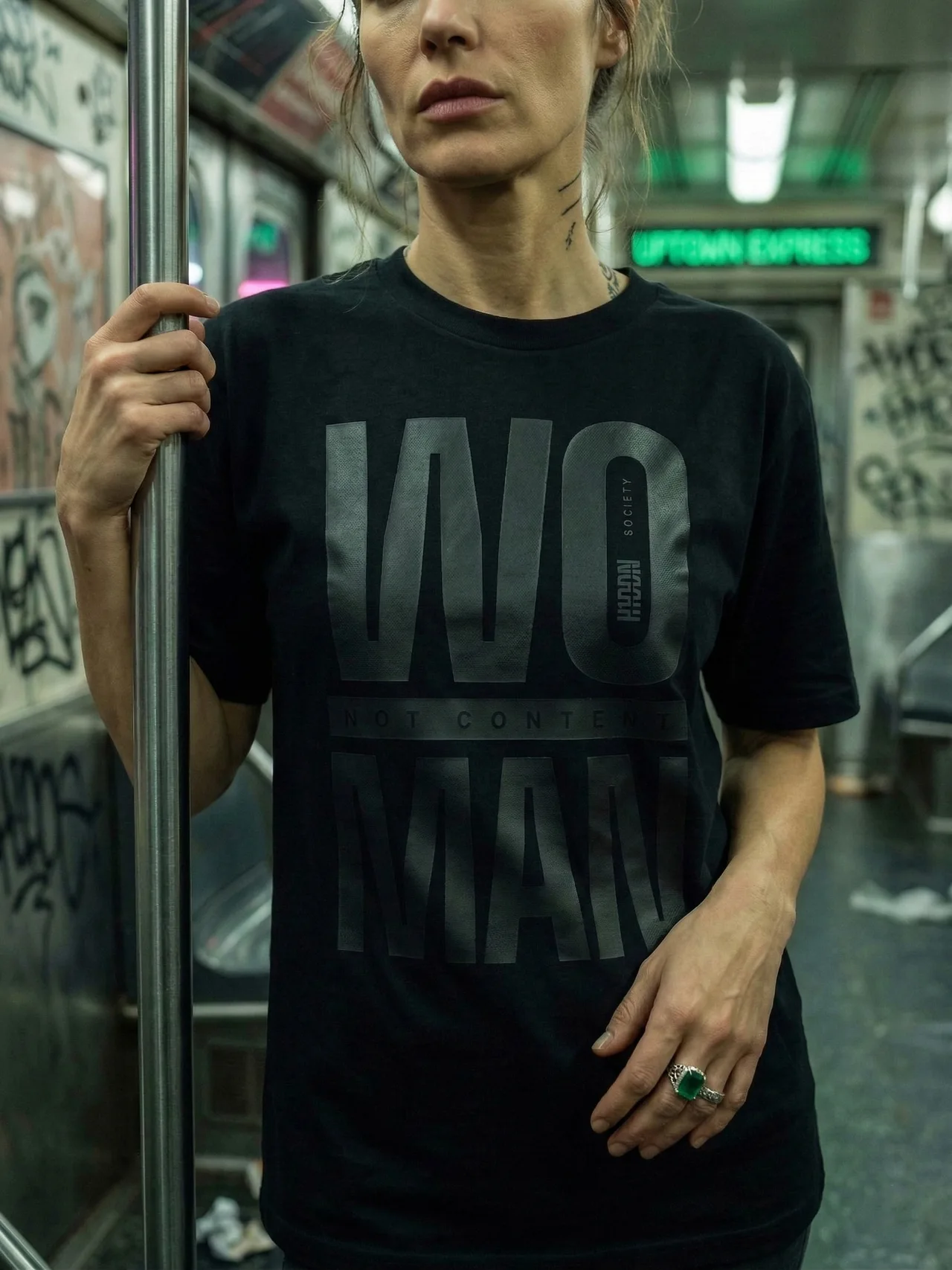 No Comment black-on-black T-shirt worn on an underground train